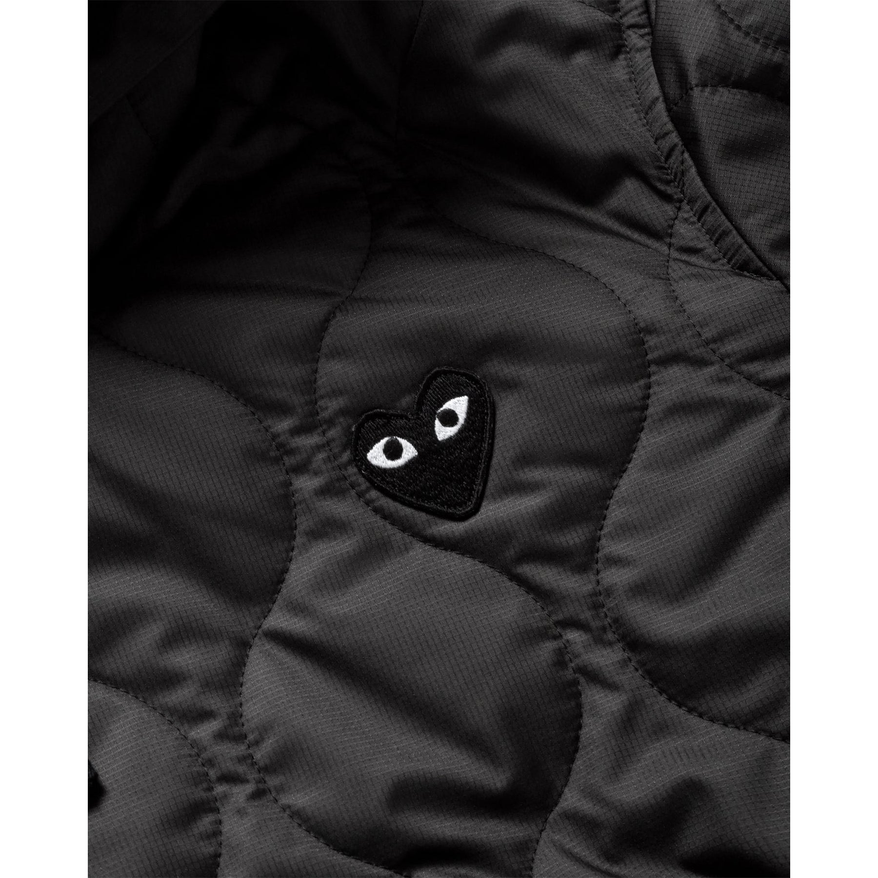 COMME des GARÇONS PLAY quilted hooded jacket, close up with black heart embroidery