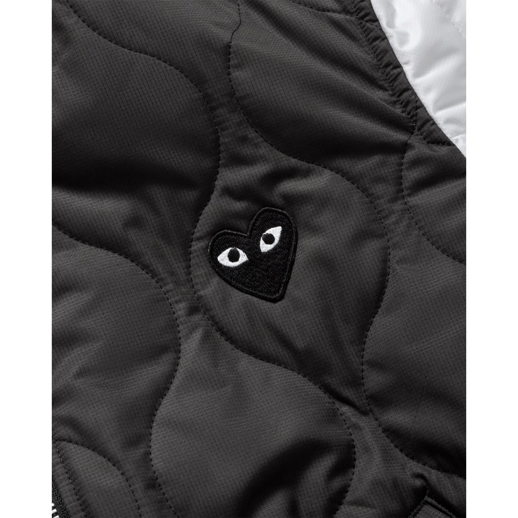 COMME des GARÇONS PLAY varsity jacket, close up with black heart embroidery