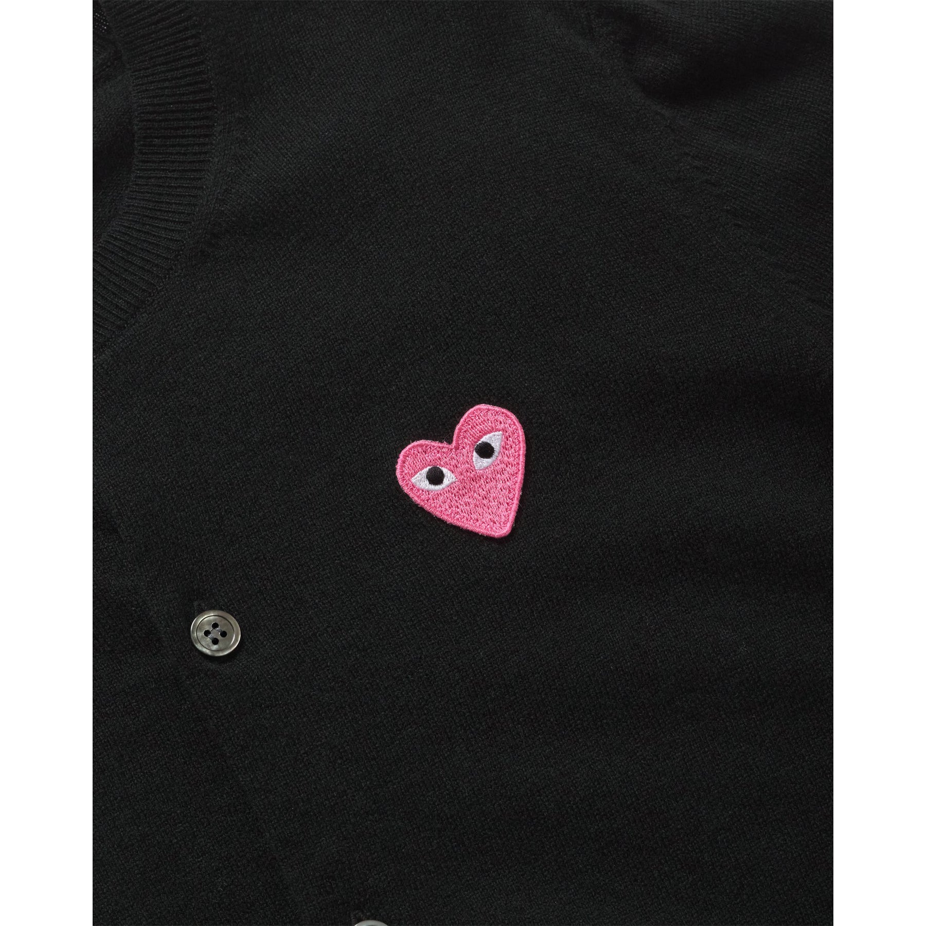 COMME des GARÇONS PLAY black wool cardigan with small pink heart logo, close up